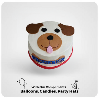 A decorated dog-shaped cake with a happy facial expression, tongue out, and a name written on the side, served on a white plate with additional party decorations mentioned as complimentary.